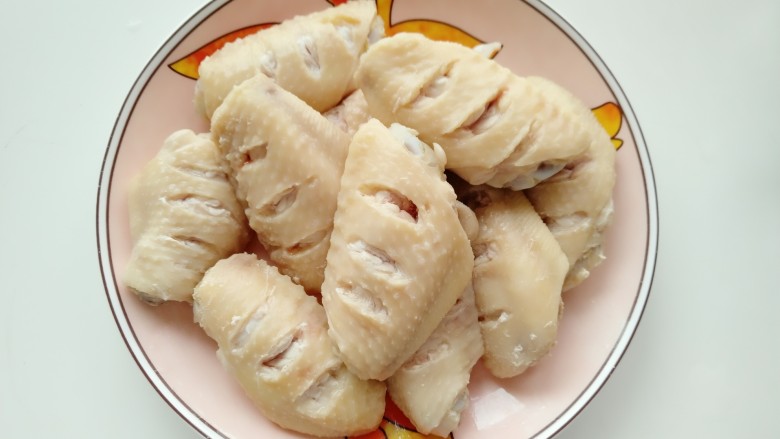 可乐鸡翅,把捞出的鸡翅用清水冲去表面浮沫,放盘沥干备用。