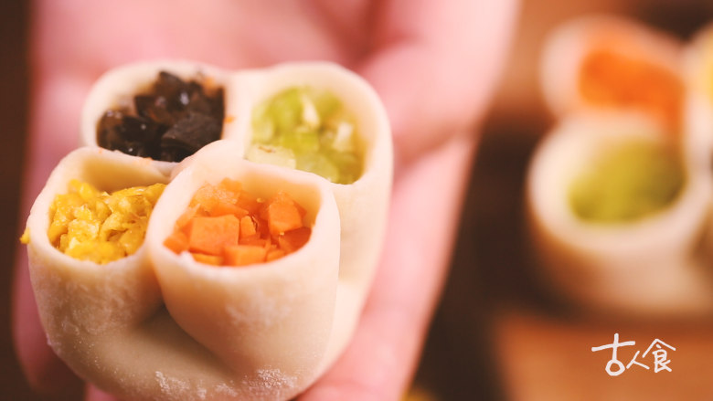 【清·四喜饺子】,将饺子放在蒸架上,再用小匙分别将四色馅料填入。