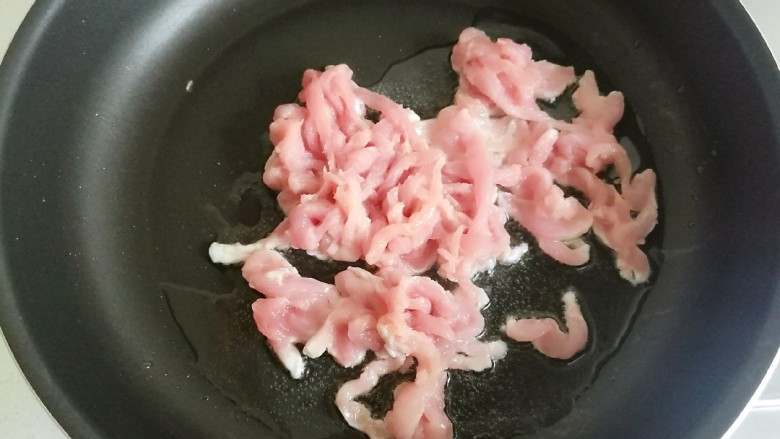 辣椒炒肉丝,炒锅里加入食用油,放入肉丝。