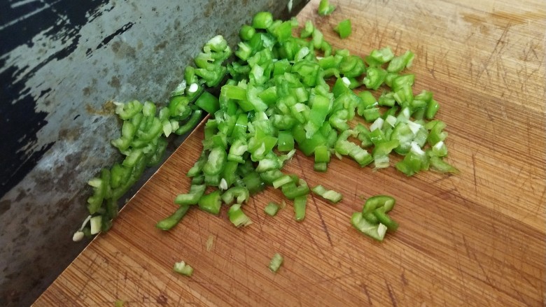 黄金鸡蛋面,趁着面糊静置的时间里,我们把食材处理一下。把洗净的<a style='color:red;display:inline-block;' href='/shicai/ 61'>青椒</a>去籽,切成末备用。