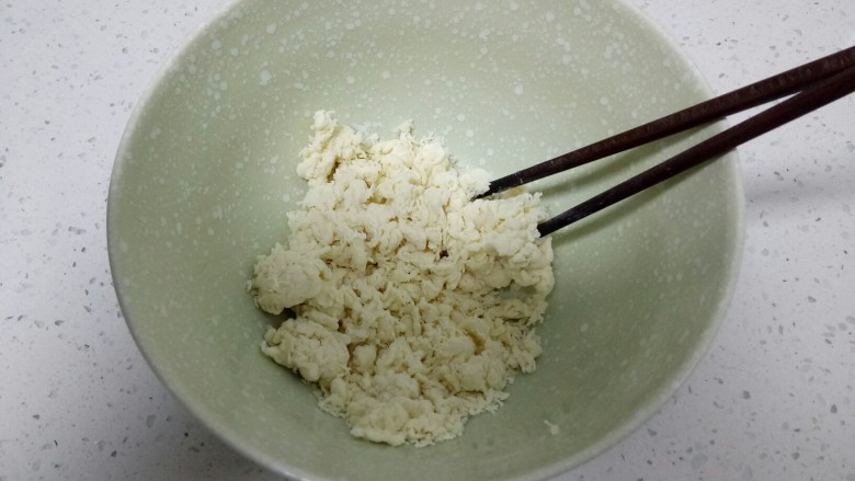 两种口味的夹馍,一边倒入酵母水,一边用筷子搅拌,搅拌至絮状。
