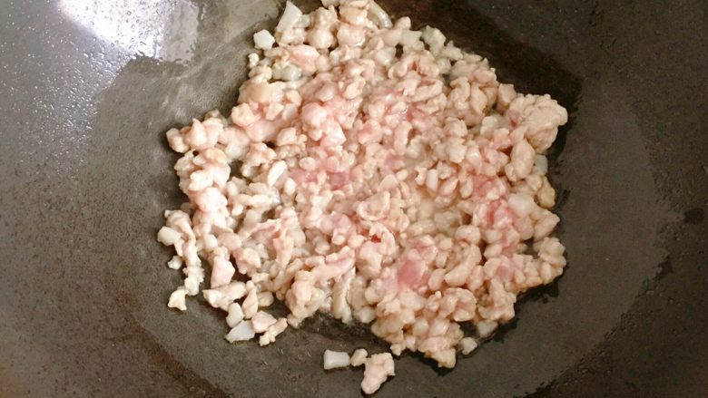 肉末炒豆角,锅中倒入适量油烧热,放入腌制好的肉末迅速炒散至肉变色;