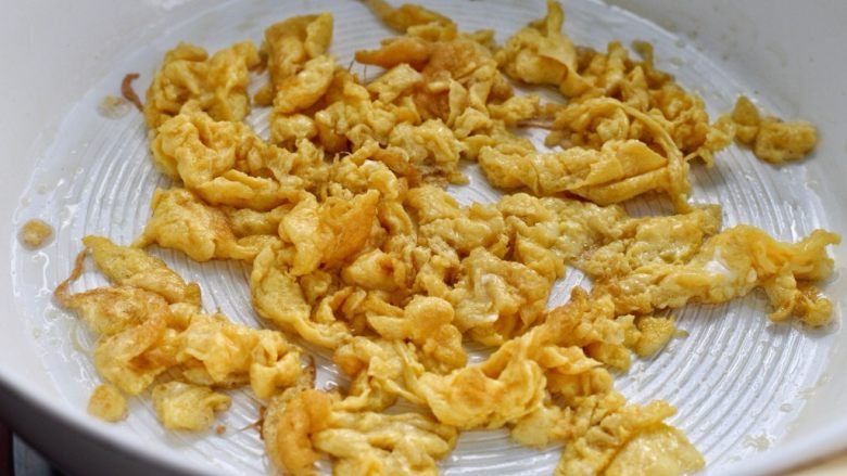 虾仁蛋炒饭,另起锅放适量食用油烧热,倒入打散的蛋液炒熟捣碎盛出