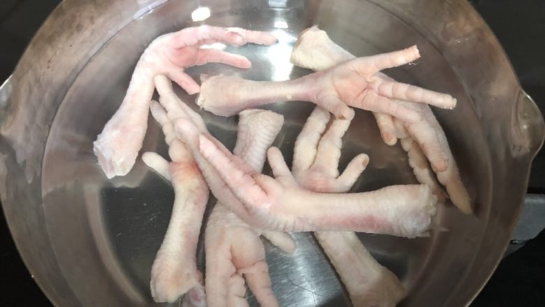 卤香鸡爪,鸡爪放入锅中