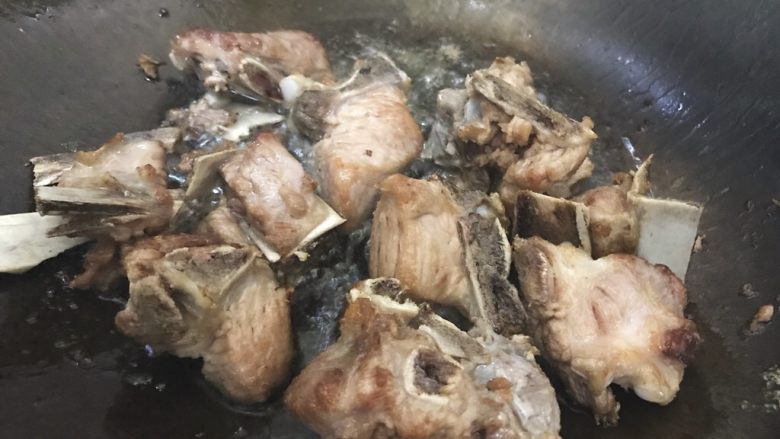 巨好吃的西红柿烧排骨,待锅内油七分热时,下排骨,翻炒至排骨变成金黄色