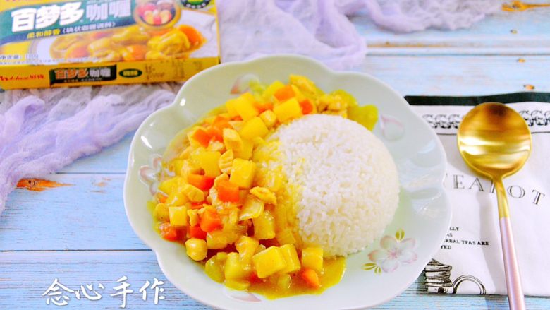 咖喱鸡肉饭,用勺子装入适量的咖喱鸡肉,再淋点汤汁上去