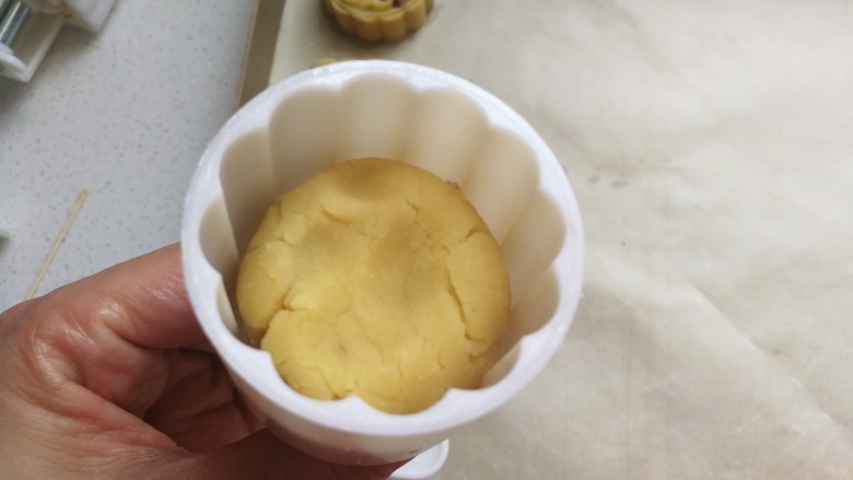 清凉甜点~蔓越莓绿豆糕,然后把月饼模具提前刷上一层融化的黄油或植物油,再取一份豆沙团放入模具中用手稍微压一下。