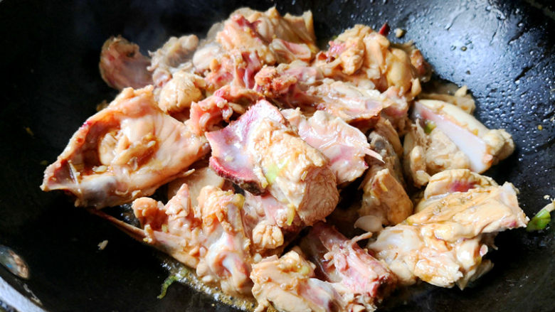 鸡架粉皮汤,倒入鸡架翻炒,让每一块鸡架都沾到酱汁,鸡架上肉不是很多很厚,所以很容易炒熟,