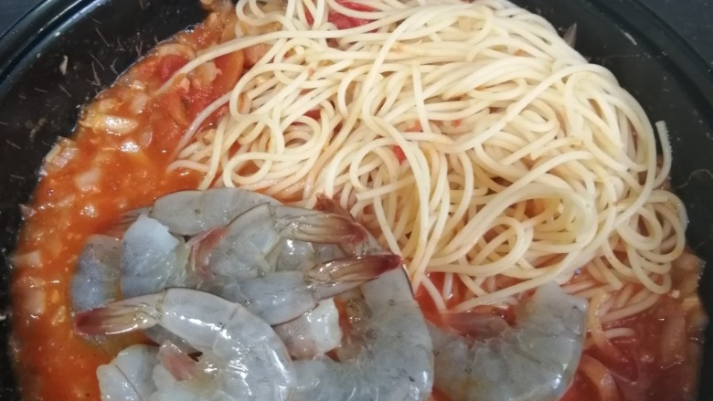 蒜香虾番茄酱意面拼香菜鸡扒,放入虾和意面同煮,再放入少量的料酒淋于锅边。