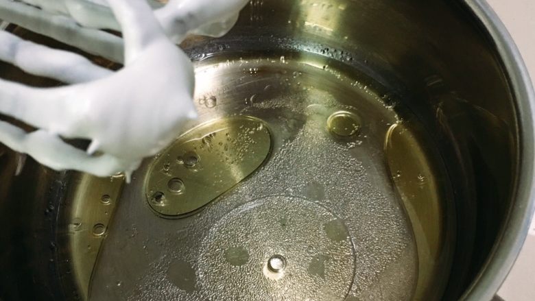6寸方模戚风蛋糕,油和水混合,加入盐和15克细砂糖,用打蛋器低速搅打十几秒,油水融合,细砂糖溶解。