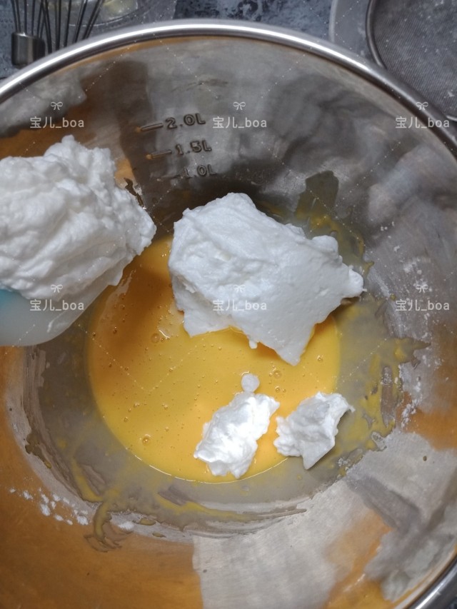 烘焙新手都成功的戚风蛋糕,盛出1/3蛋白到蛋黄糊中,用橡皮刮轻轻翻拌均匀,从底部往上翻拌,不要划圈圈哦,以免蛋白消泡