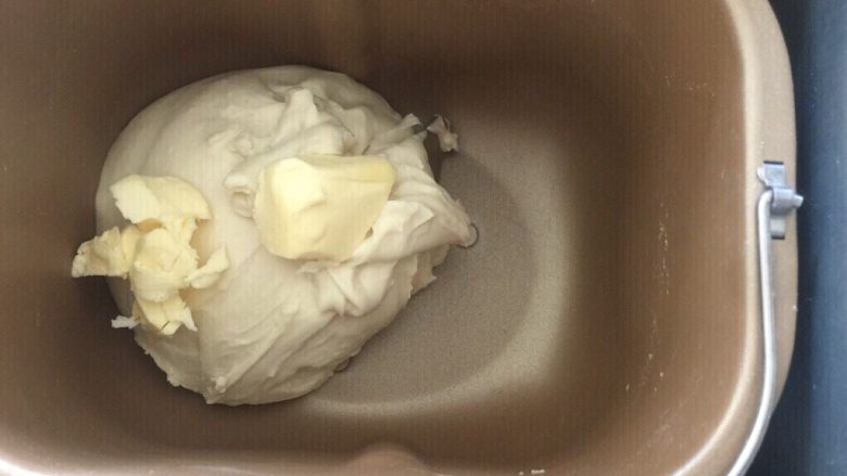 佛系养生黑芝麻辫子面包,第七步:加入软化的黄油再次启动揉面程序