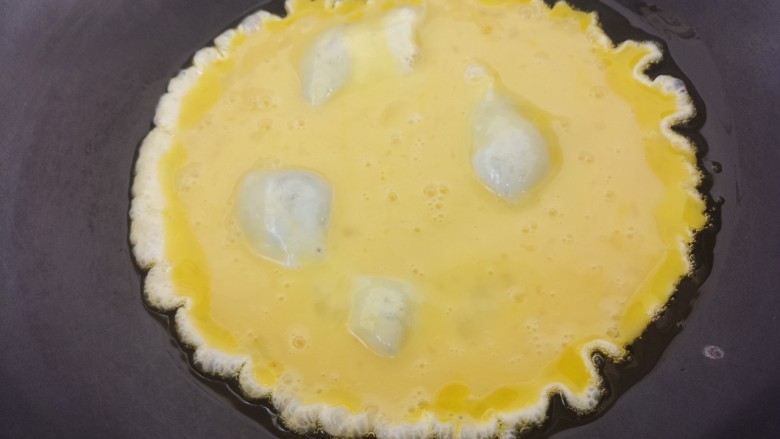 洋葱炒鸡蛋,把鸡蛋放进锅里小火炒。