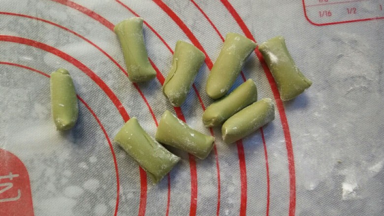 寿桃豆沙包,将绿色面团揉成条状,然后切割为9等份。