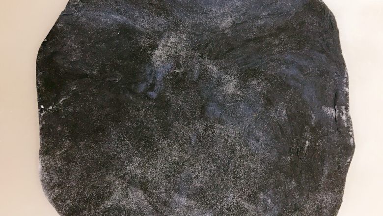 星空吐司,黑色面团擀开,放了一点黑加仑葡萄干,也卷成长条,放在吐司盒中间