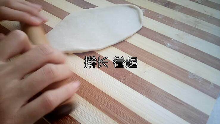 葱香芝士面包,取一个面团 用擀面杖擀成牛舌状