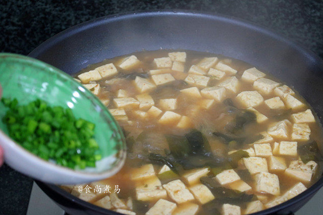 裙带菜大酱豆腐汤,撒下葱花,拌匀即可舀起食用。