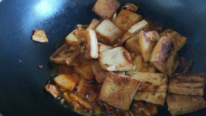 新文美食 红烧冻豆腐,在倒煎制好的冻豆腐,<a style='color:red;display:inline-block;' href='/shicai/ 135284'>美味鲜酱油</a>,炒均匀。