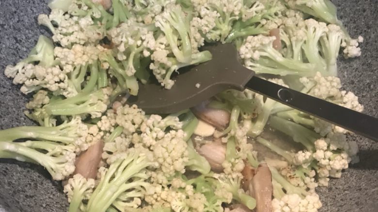 花椰菜炒五花肉,加入一点水,盖上锅盖焖一下,至花菜软