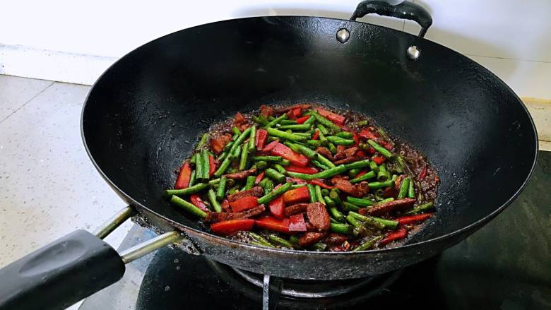 豇豆胡萝卜焖面,<a style='color:red;display:inline-block;' href='/shicai/ 60'>豇豆</a>胡萝卜入锅,炒出香味,倒入老抽、糖,盐。