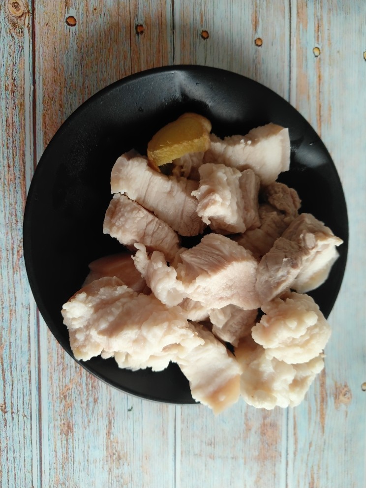 五花肉烧莲藕,焯完水的五花肉用清水冲洗干净,沥干水分。