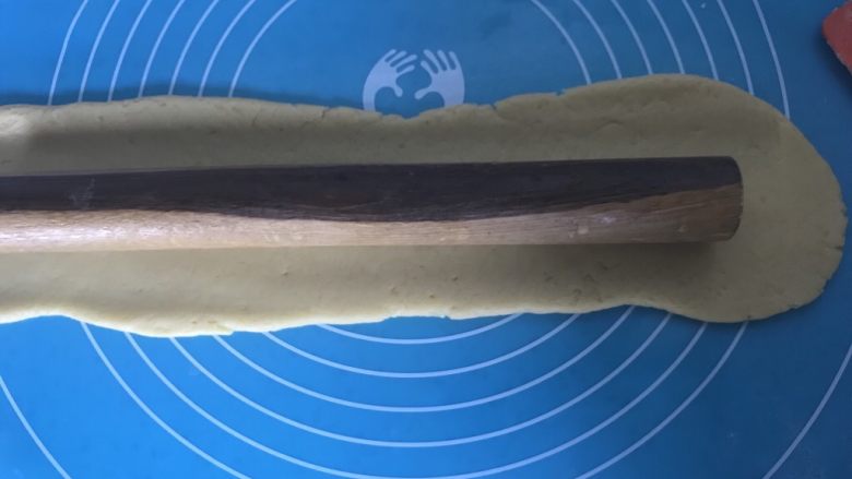 宝宝零食必备~奶香豆沙一口酥,用擀面杖轻轻擀开,宽度是原来的3倍左右。