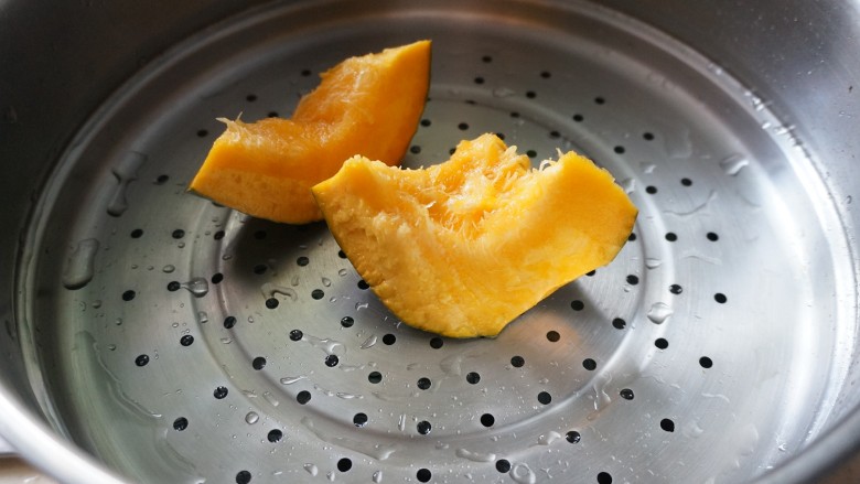 南瓜核桃红糖肉桂卷,南瓜洗净后上锅蒸,用筷子戳的进就可以,蒸好的南瓜压成泥冷却后备用