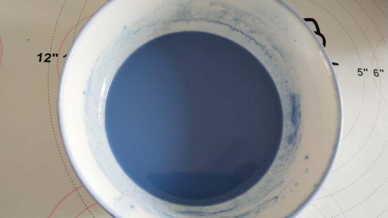 蝶豆花海洋蛋糕,蝶豆花牛奶溶液晾凉以后用筛子过滤出50克的蝶豆花牛奶!蝶豆花牛奶溶液倒入<a style='color:red;display:inline-block;' href='/shicai/ 846'>色拉油</a>中,用打蛋器完全搅拌均匀