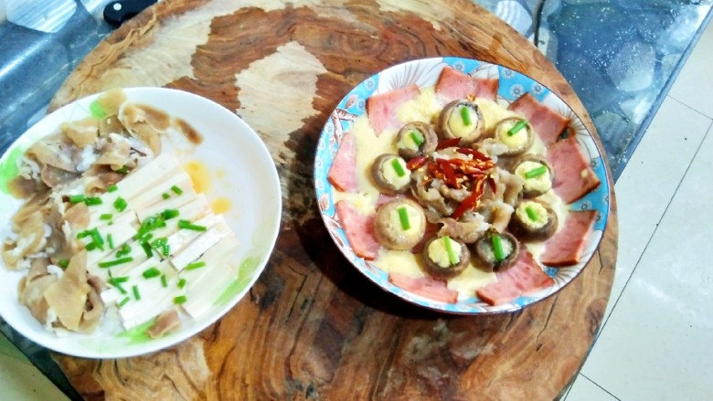 蘑菇抱蛋,取出蒸熟的菜(老贱的锅盖透明的,口蘑变色,蛋液凝固就表示熟了,若取出时盘中有蒸汽水,放置一会倒去淤水),剪取若干辣椒丝,熟少量热油淋在上面爆香即可。点缀葱叶,美不胜收。