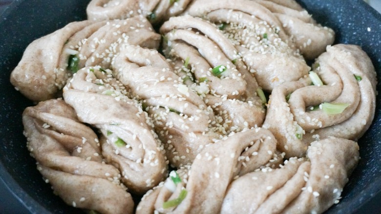 脆底黑麦粘卷子,水收干后撒上芝麻和葱末,从锅边淋入少许油转下锅,底部脆了就👌了