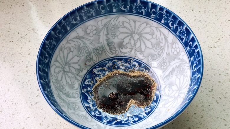 铸铁珐琅锅·红烧牛肉面,碗里倒入少许生抽和白胡椒粉;