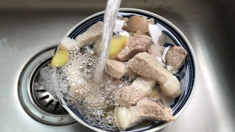 腐皮红烧肉(懒人版),捞出煮好的五花肉用流动水冲洗干净表面的脏东西