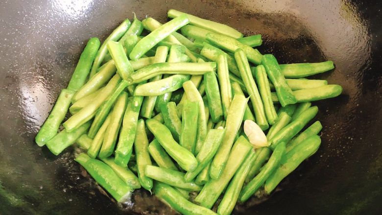 爆炒四季豆-适合上班族的快手菜,炒至大部分豆子变色时倒入半碗水(吃饭的碗)