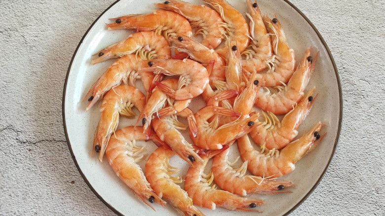 白灼虾,把捞出来的大虾沥水,摆在盘里