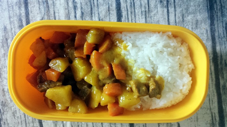 秒杀外卖的咖喱牛肉饭,然后找一个饭盒装入米饭和做好的咖喱土豆牛肉。