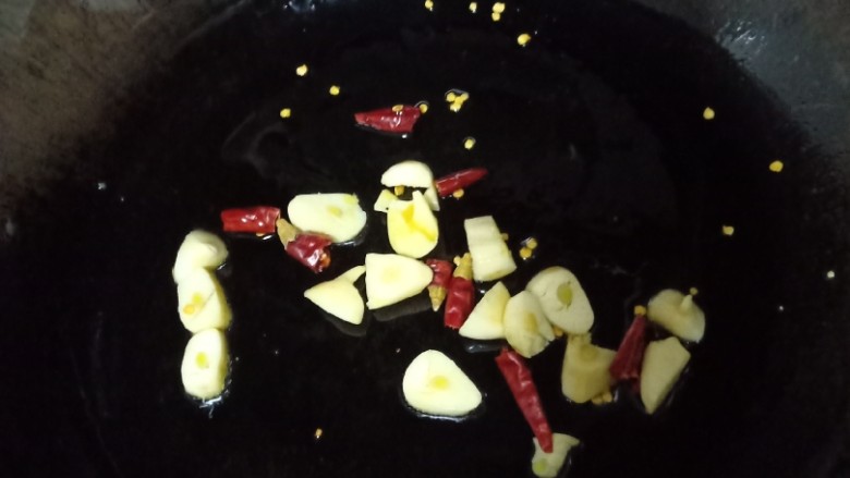 十味 爆炒茄子豆角,锅里剩余的油用碗装起来,只留一小部分在锅里,把大蒜和干辣椒放锅里煸炒出香味。