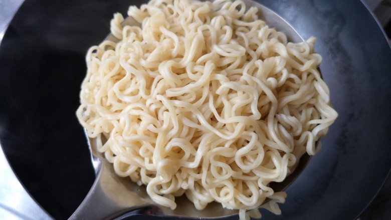 十味 鲜虾鱼板面,将煮好的面沥水捞出(可过一下凉开水增加面的弹性),煮面的水倒掉。