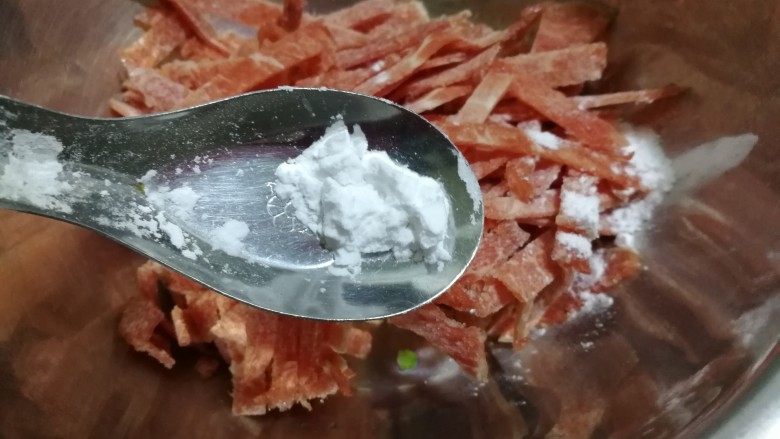 牛肉蒜薹炒蛋条,切好的牛肉放到了小盆儿里,撒半勺淀粉拌匀放置一会,这样牛肉炒起来会很嫩。
