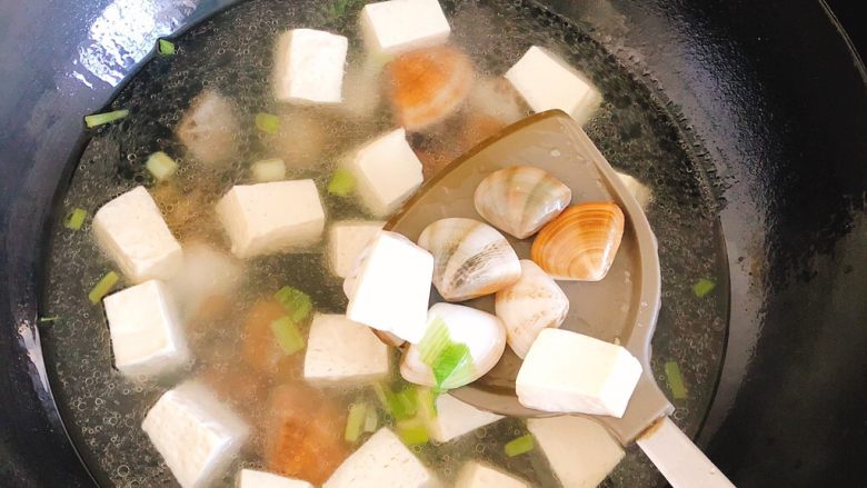 豆腐花哈汤,锅里水开1分钟后,倒入花蛤。