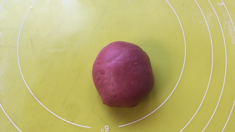 双色牛角酥,剩下的一小块面团加入红曲粉,用手掌一直向前推揉面团,将面团揉至均匀的红色