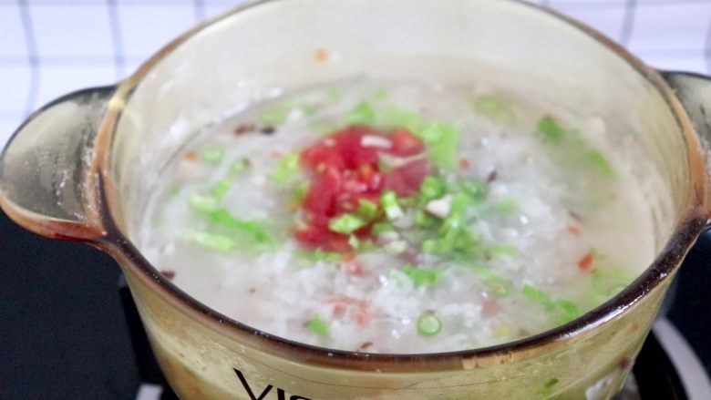 杂蔬肉松粥,胡萝卜丁软烂后,加入生菜碎和西红柿丁,继续煮2min