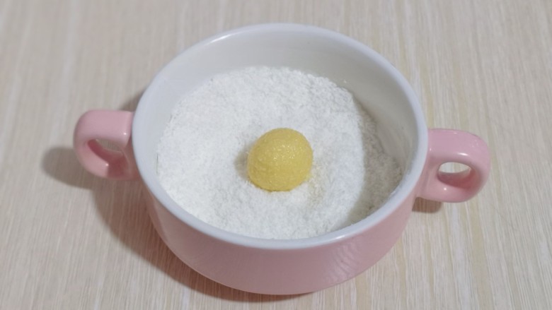 黄金椰蓉球一口一个令人回味,取一小块轻轻揉圆,放入椰蓉器具中,使每个小球均匀裹上椰蓉!
