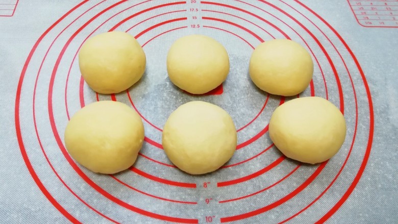 甜味面包卷,从盆里取出排气,分成六份。