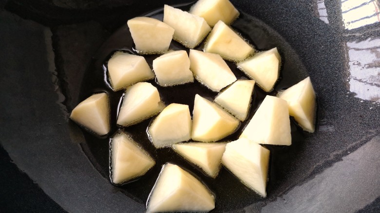 百吃不厌的下饭菜——地三鲜（免油炸健康版）,锅中少量油，50毫升左右（根据食材量增减），烧热下入土豆块，中小火煎。土豆和茄子熟的时间不同，所以需要分开煎。