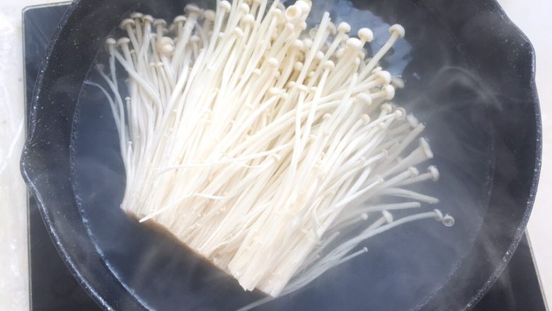 酱香烤鱼,锅内加水烧开,将金针菇入热水中煮两分钟,捞出备用