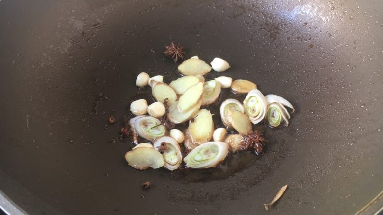 红烧鲢鱼,热锅凉油,放入葱姜蒜和八角,爆出香味。