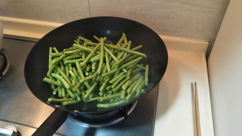 过年菜的标配——糖醋烤豇豆,倒入洗净的缸豆煸炒。