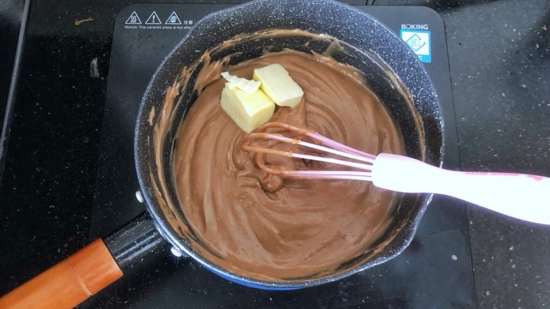 可可冰心面包,17、加热至蛋奶糊变得浓稠即可离火,趁热加入黄油搅拌至完全融化,棉花糖可可卡仕达酱就做好了。