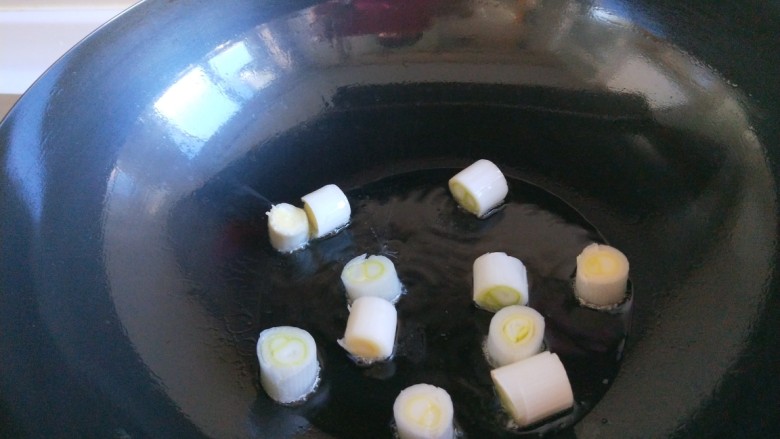 新文美食 懒人简便宫爆鸡丁,锅中倒入适量油烧热,放入葱段翻炒均匀。