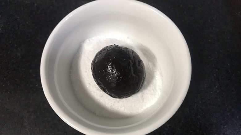 裂纹巧克力软饼干,放入糖粉碗里,滚圆沾满糖粉。
